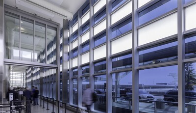 Glass walled building interior view with people walking